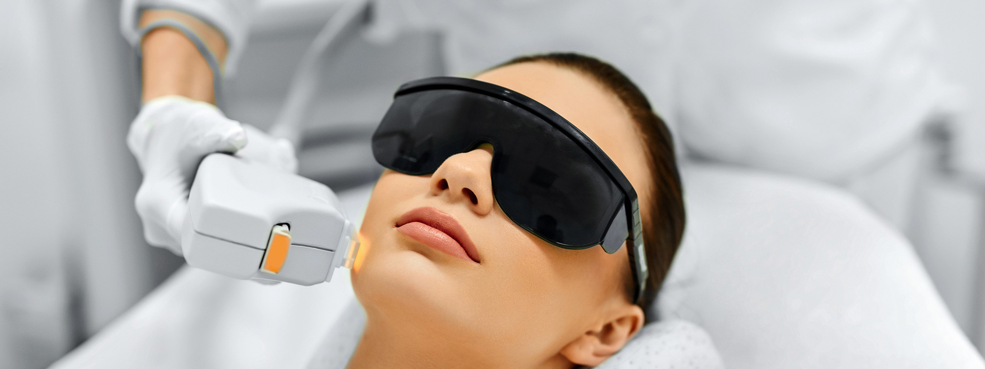 A beautiful woman is receiving IPL treatment.