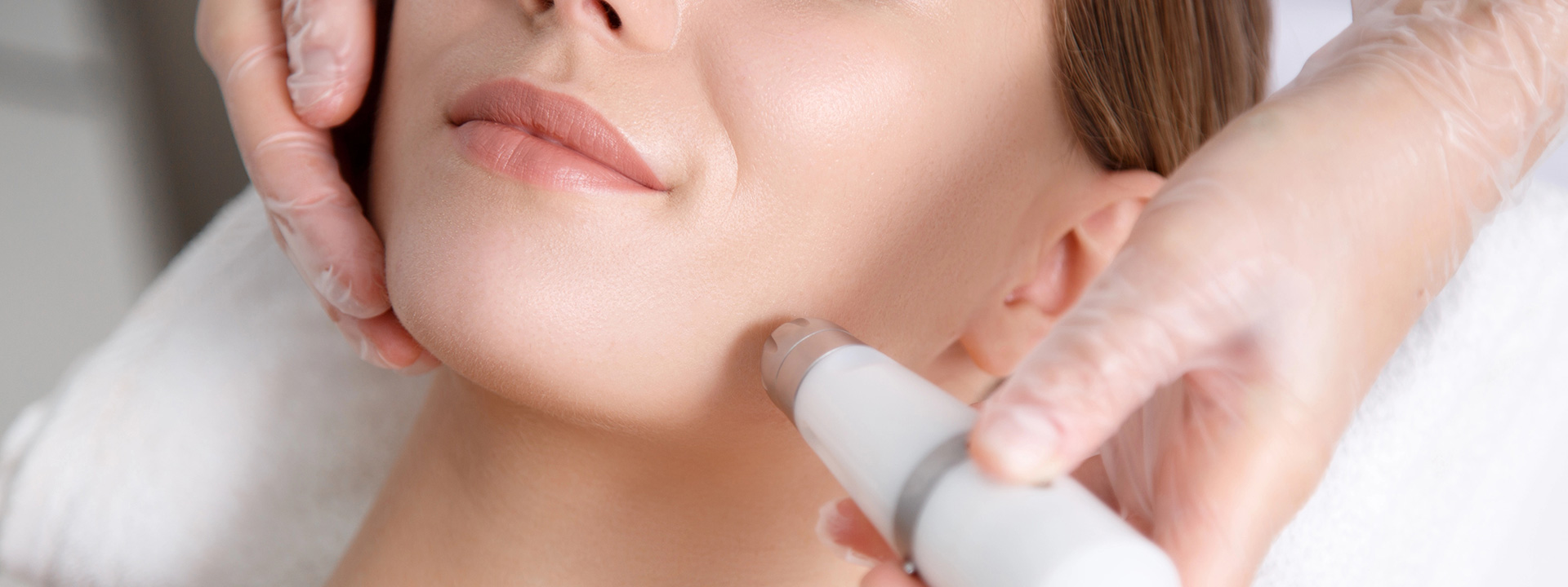 A beautiful woman is receiving laser treatment.
